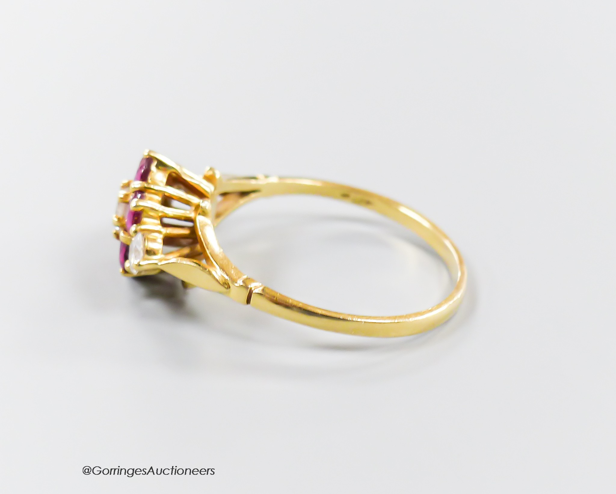 A modern 18ct gold, ruby and diamond set cluster ring, size T, gross 3.8 grams.